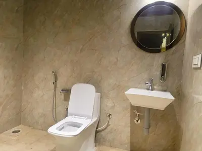 a bathroom with a toilet and a sink and a mirror at The Cozy Clouds Hill Stay in Napoklu