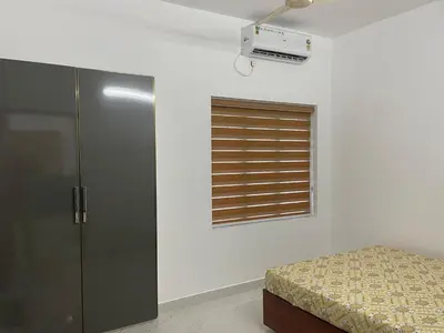 a bedroom with a bed and a window at RoyalGiri Apartment near Rajagiri Hospital in Alwaye