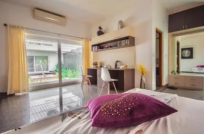 a bedroom with a bed with a purple pillow on it at Resort Type Three Bed Room Villa in Trichūr