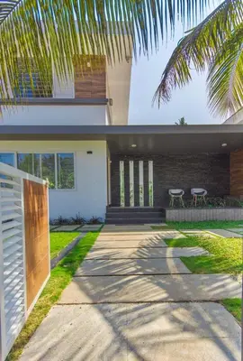 a house with two chairs in front of it at Resort Type Three Bed Room Villa in Trichūr