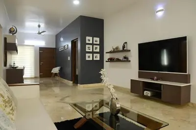 a living room with a couch and a tv at Resort Type Three Bed Room Villa in Trichūr