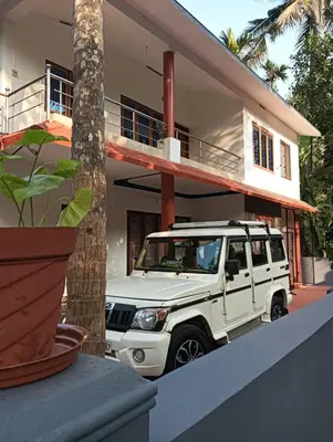 a white jeep parked in front of a house at Home in kannur in Kannur