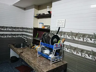 a kitchen with a counter with a sink and a counter sidx sidx at Home in kannur in Kannur