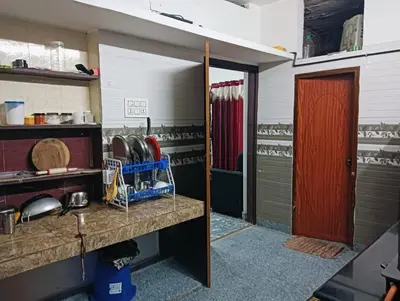 a kitchen with a red door and a sink at Home in kannur in Kannur