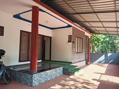 a house with a motorcycle parked in front of it at Home in kannur in Kannur