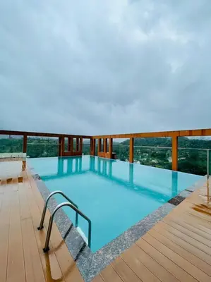 a large swimming pool on top of a building at Aaram Miraj Luxuria Apartment -1 in Wayanad