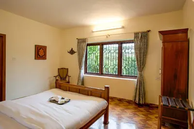 a bedroom with a bed and a window at Away From Home - 2 - Rooms In Ooty, Home Stay Ooty in Ooty