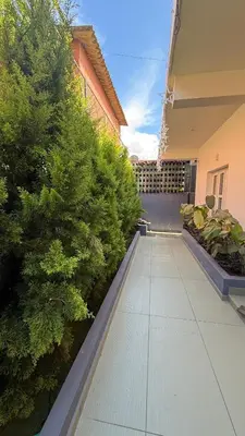 a walkway in front of a building with plants at Leafy Mist Villa in Munnar