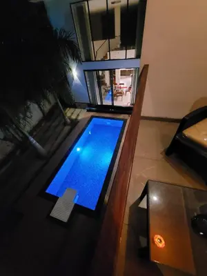 an overhead view of a swimming pool in a living room at Aurora-The Pool Villa in Kozhikode