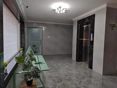 a hallway with a table and plants in a building at 7 Elysee Homestay - Safire - Premium 3BHK Family Flat in Trichūr