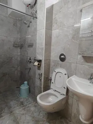 a bathroom with a toilet and a sink at 7 Elysee Homestay - Safire - Premium 3BHK Family Flat in Trichūr