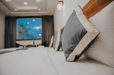 a hotel room with a bed with a pillow at Saj Heritage in Kalpetta