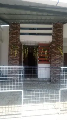 a building with a porch with wreaths on it at Stay Castle in Guruvāyūr