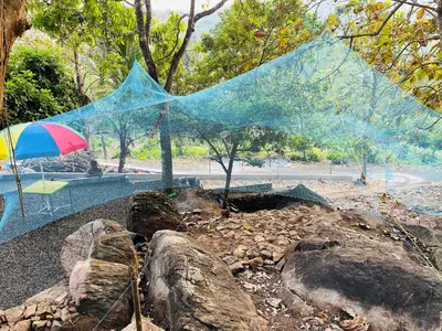 a net is hanging over a rock garden at Rock Hill - Pachakkad Home Stay in Athirappally