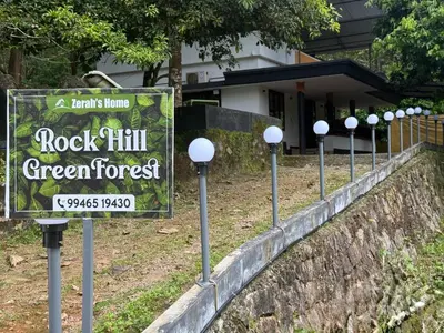a sign for a rock hill green forest at Rock Hill - Pachakkad Home Stay in Athirappally