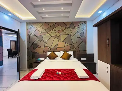 a bedroom with a large bed and a wall at Crystal Winter Arcade wayanad in Wayanad