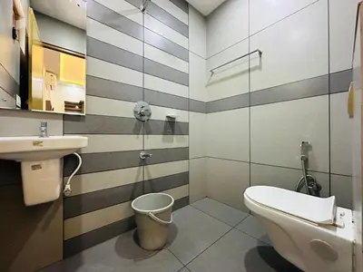 a bathroom with a toilet and a sink at Crystal Winter Arcade wayanad in Wayanad