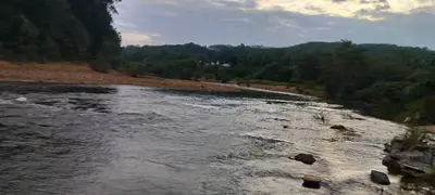 a river with rocks on the side of a mountain at Entire Villa Homestay Rooms IRITTY in Irrity