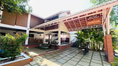 a building with a motorcycle parked in front of it at Monarda Resort in Padinjarathara