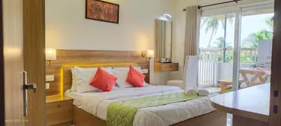 a hotel room with a bed with red pillows at Sree Nandhanam apartment's in Guruvāyūr