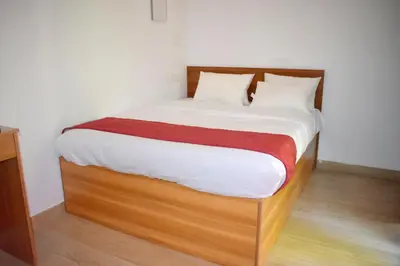 a bedroom with a bed with a wooden bed frame at Forest Brew Resort Wayanad in Chekadi