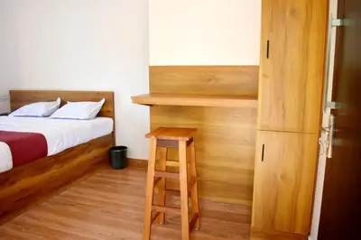 a bedroom with a bed and a ladder and a bed and a stool at Forest Brew Resort Wayanad in Chekadi