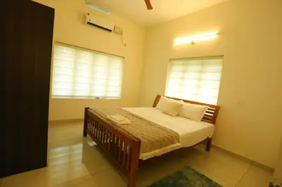 a bedroom with a bed and a window at Welcome to SP Luxury Bed Villa in Kāladi