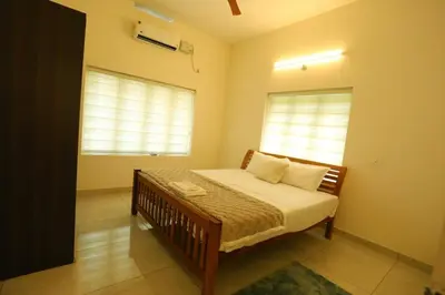 a bedroom with a bed and a window at Welcome to SP Luxury Bed Villa in Kāladi