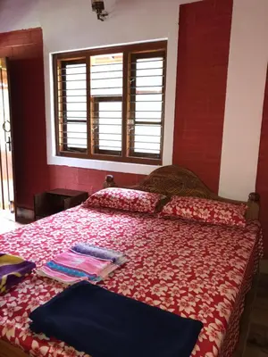 a bedroom with two beds and a window at Snow Drop Villa in Gonikoppal