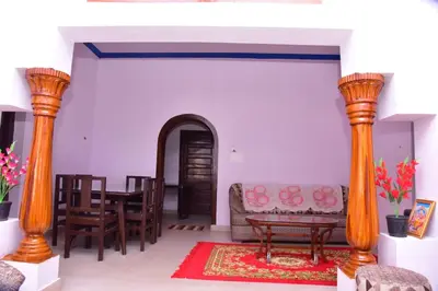 a living room with a couch and a table at Snow Drop Villa in Gonikoppal