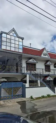 a white house with a staircase in front of it at Shariff Villa in Mysore
