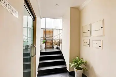 a hallway with a staircase in a building at Hotel Grand Regency, Angamaly in Angamali