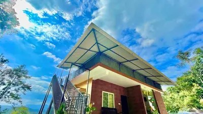 a house with a glass roof on top of it at Elegant Mountain Resort in Kalpetta