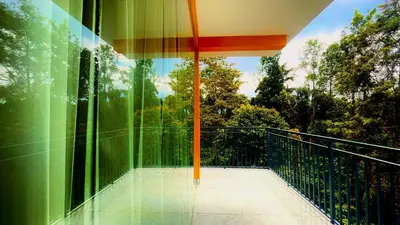 a balcony with a view of the trees at Elegant Mountain Resort in Kalpetta