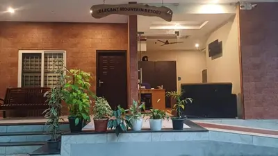 a group of potted plants sitting in a lobby at Elegant Mountain Resort in Kalpetta