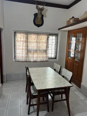 a dining room with a table and chairs and a window at Heart of Mysore - Entire Place for yourself in Mysore