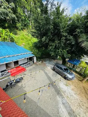 a car parked in a parking lot next to a building at Greenwoods Munnar Unmarried Allowed in Munnar
