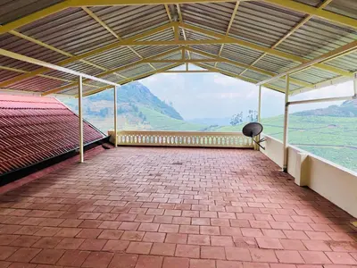 a large pavilion with a view of a mountain at Away From Home - 1 - Rooms In Ooty, Home Stay Ooty in Ooty