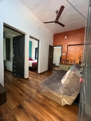 a bedroom with a bed and a ceiling fan at Dragster Pool Villa in Māla