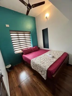 a bedroom with a bed and a green wall at Dragster Pool Villa in Māla