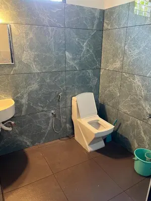 a bathroom with a toilet and a sink at Dragster Pool Villa in Māla