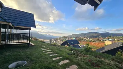 a house on a hill with a pathway leading up to it at Fairyland Resort in Kodaikānāl