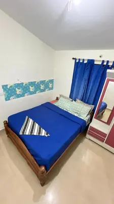 a blue bed in a room with a window at Chillz Heaven Resorts - Ketti Palada in Coonoor