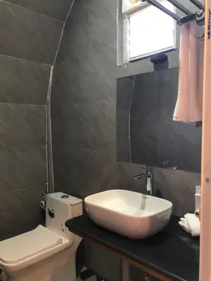 a bathroom with a sink and a toilet at Galaxy Garden Resort in Kallār