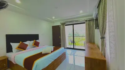 a bedroom with a large bed and a window at Brighton Stays in Sultan Bathery
