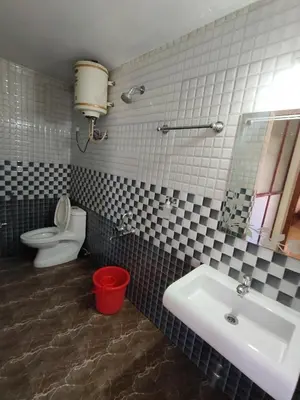 a bathroom with a sink and a toilet at R R K Residency in Ooty