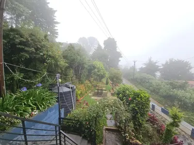 a view of a garden with flowers and plants at R R K Residency in Ooty