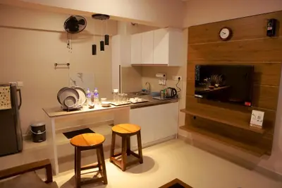 a kitchen with two stools and a counter in a kitchen at Luxairy in Chewarra
