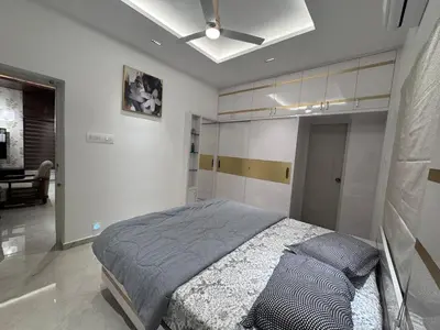 a bedroom with a bed and a ceiling at Vels Villa A home away from home at Pollachi in Pollāchi
