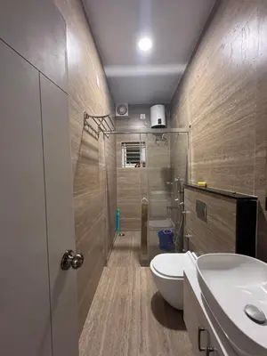 a bathroom with a shower and a toilet and a sink at Vels Villa A home away from home at Pollachi in Pollāchi